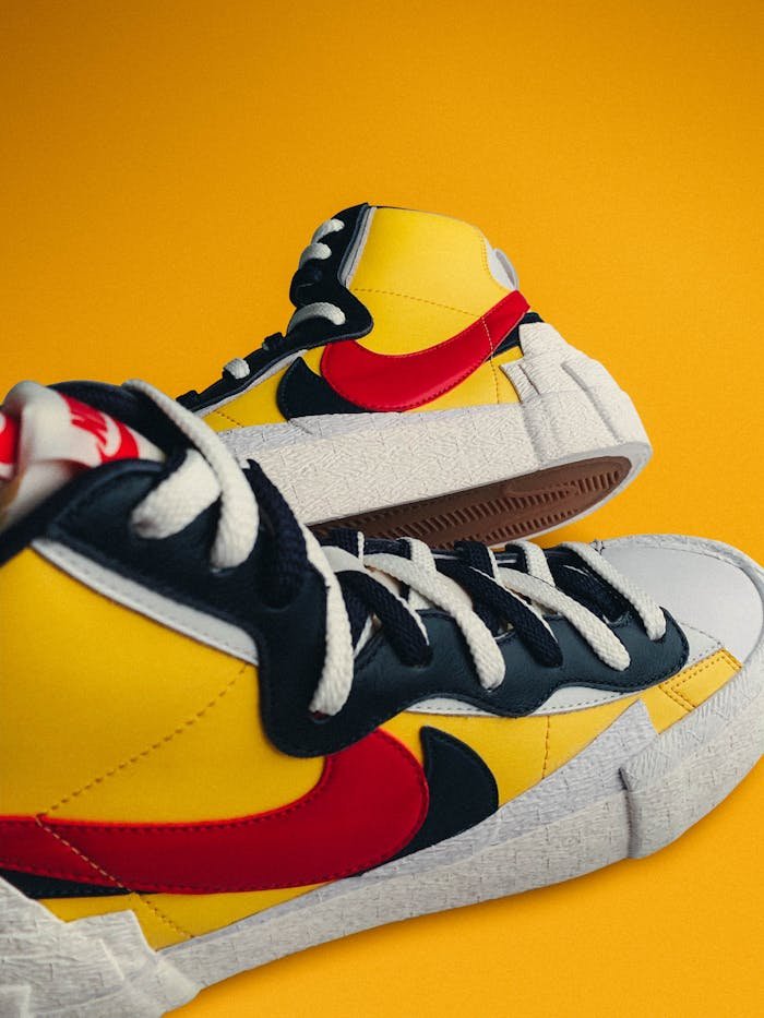 services-01 High-top sneakers with vibrant colors on a striking yellow backdrop.
