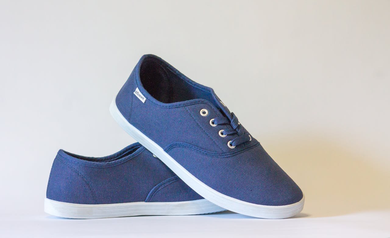 team-01 Pair of stylish blue canvas shoes with white soles displayed against a neutral background.